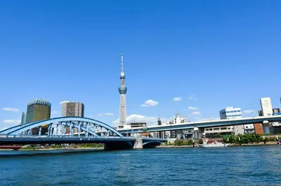 a bridge over a river with a city in the background at \u30a2\u30f3\u30c9\u30b9\u30c6\u30a4\u6d45\u83495\u4e01\u76ee1f in Tokyo