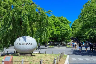 a large cement ball in a park with people walking at \u30a2\u30f3\u30c9\u30b9\u30c6\u30a4\u6d45\u83495\u4e01\u76ee2f in Tokyo