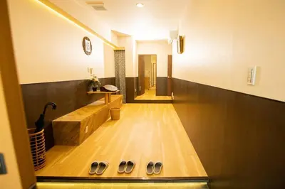 a hallway with a row of shoes on the floor at \u30a2\u30f3\u30c9\u30b9\u30c6\u30a4\u6d45\u83495\u4e01\u76ee2f in Tokyo