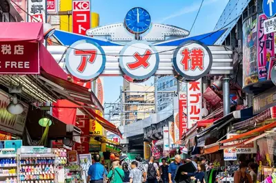 a street with people walking through a market with signs at \u30a2\u30f3\u30c9\u30b9\u30c6\u30a4\u6d45\u83495\u4e01\u76ee2f in Tokyo