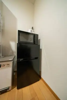 a microwave sitting on top of a black refrigerator at Seibu Shinjuku Station 2 min walk Shin-Okubo Station 6 min walk,4 people can stay ISJ35 in Tokyo