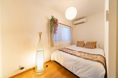 a small bedroom with a bed and a window at Seibu Shinjuku Station 2 min walk Shin-Okubo Station 6 min walk,4 people can stay ISJ35 in Tokyo