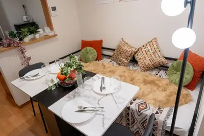 a table and a couch in a living room at Seibu Shinjuku Station 2 min walk Shin-Okubo Station 6 min walk,4 people can stay ISJ35 in Tokyo