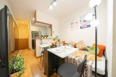 a kitchen and living room with a table and a couch at Seibu Shinjuku Station 2 min walk Shin-Okubo Station 6 min walk,4 people can stay ISJ35 in Tokyo