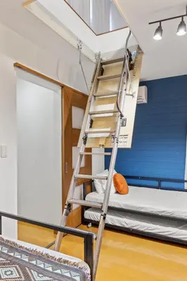 a ladder in a room with a bunk bed at Tokyo Shinjuku Group Stay-Up to 16 Guests ISJ36 in Tokyo