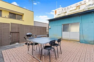 a patio with a table and chairs and a grill at Tokyo Shinjuku Group Stay-Up to 16 Guests ISJ36 in Tokyo