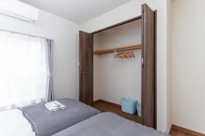 a bedroom with a bed and a large window at Kosumosu in Tokyo