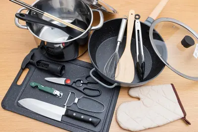 a cutting board with a pan and other kitchen utensils at Kosumosu in Tokyo