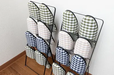 a bunch of chairs lined up against a wall at Kosumosu in Tokyo