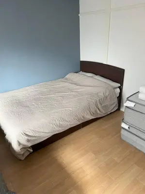 a bedroom with a bed and a wooden floor at G&R House301 in Tokyo