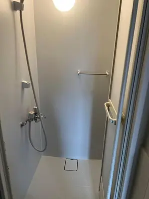 a bathroom with a shower and a toilet with a light at G&R House301 in Tokyo