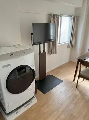 a living room with a tv on top of a microwave at G&R House301 in Tokyo