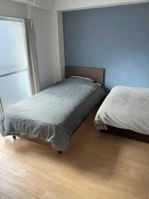 a bedroom with two twin beds and a window at G&R House301 in Tokyo