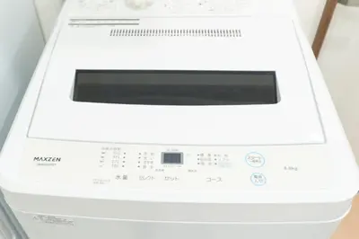 a white washing machine sitting on a counter at GRANQUAL Horikiri by Tranova in Tokyo