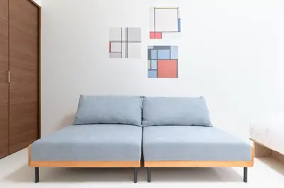 a tufted blue ottoman in a bedroom at GRANQUAL Horikiri by Tranova in Tokyo