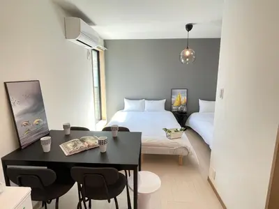 a hotel room with a bed and a table and chairs at COMMA HOUSE Kitaikebukuro 303 in Tokyo