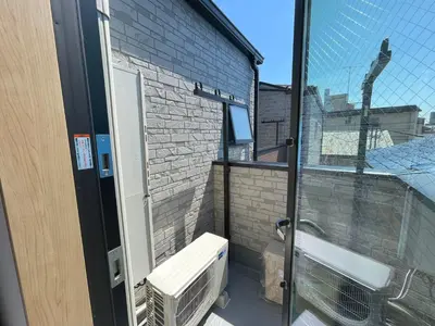 an open door to a balcony with a window at COMMA HOUSE Kitaikebukuro 303 in Tokyo