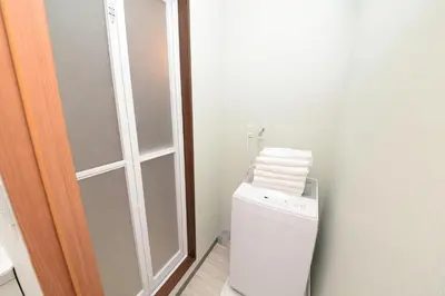 a small bathroom with a towel rack next to a toilet at \u548c\u30ce\u6953cottage\u7b2c\u4e09 \u65b0\u5bbf\u306e2\u968e\u5efa\u30664\u5ba42\u30b7\u30e3\u30ef\u30fc2\u30c8\u30a4\u30ec in Tokyo