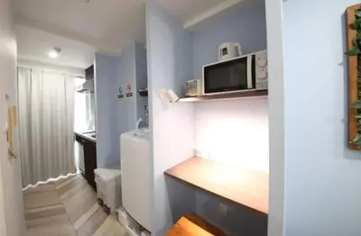 a small kitchen with a microwave on a wall at Shibuya WAVE401 SW41 in Tokyo