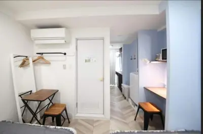 a small room with a table and a kitchen at Shibuya WAVE401 SW41 in Tokyo