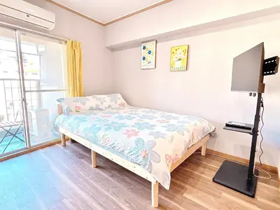 a bedroom with a bed and a flat screen tv at 406, Shinjuku City, JR Yamanote Line, 6 min walk to stn in Tokyo