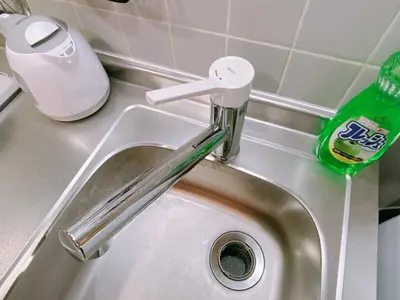 a sink with a faucet and a bottle of cleaning agent at 406, Shinjuku City, JR Yamanote Line, 6 min walk to stn in Tokyo