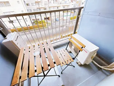 a balcony with a bench and a computer on it at 406, Shinjuku City, JR Yamanote Line, 6 min walk to stn in Tokyo