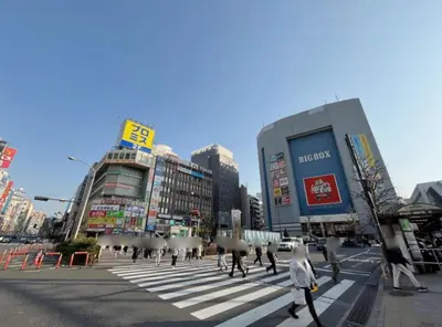 a group of people crossing a street in a city at 406, Shinjuku City, JR Yamanote Line, 6 min walk to stn in Tokyo