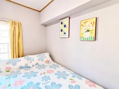 a bedroom with three pictures on the wall at 406, Shinjuku City, JR Yamanote Line, 6 min walk to stn in Tokyo