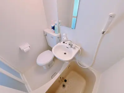 a white bathroom with a toilet and a sink at 406, Shinjuku City, JR Yamanote Line, 6 min walk to stn in Tokyo
