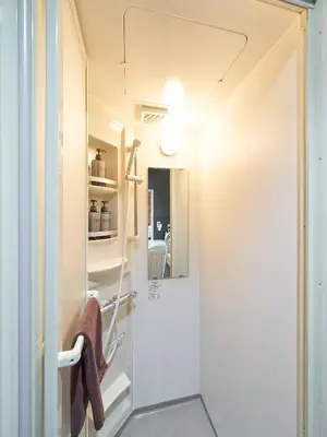 a small bathroom with a shower and a sink at Shimbashi Hotel Sho in Tokyo