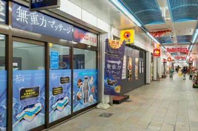 a hallway in a building with signs on the walls at \u30ed\u30fc\u30ba\u30d1\u30fc\u30af\u516b\u756a\u9928 in Tokyo
