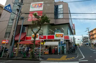 a store on a street corner in a city at \u30ed\u30fc\u30ba\u30d1\u30fc\u30af\u516b\u756a\u9928 in Tokyo