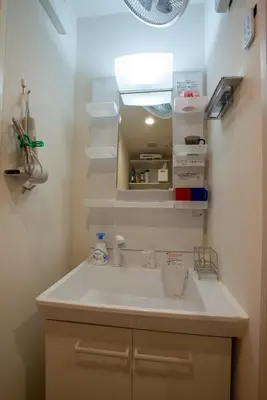 a bathroom with a sink and an open refrigerator at \u30ed\u30fc\u30ba\u30d1\u30fc\u30af\u516b\u756a\u9928 in Tokyo