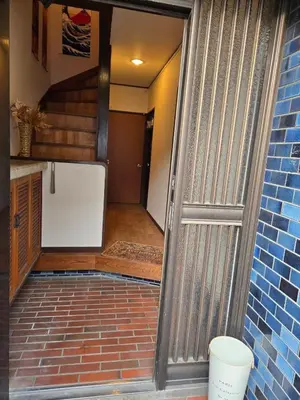 an open door to a garage with a brick floor at BandK Kouenji in Tokyo