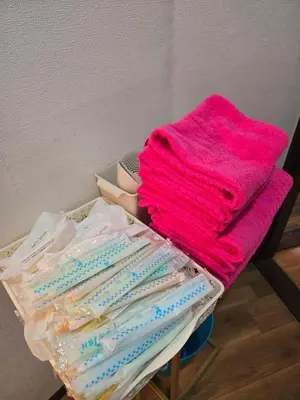 a pile of toothbrushes and a pink towel on a table at BandK Kouenji in Tokyo