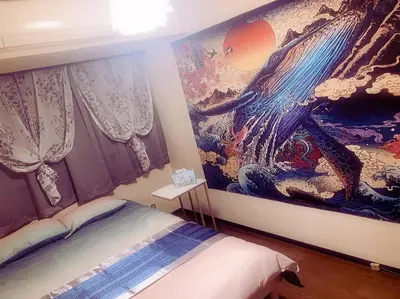 a bedroom with a large painting on the wall at BandK Kouenji in Tokyo