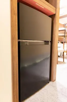 a glass door with a wooden frame on a wall at Vistalia in Tokyo