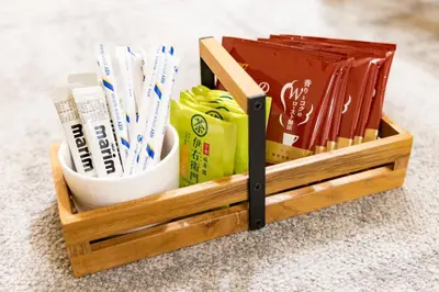 a wooden toothbrush holder with toothbrushes and books at Vistalia in Tokyo