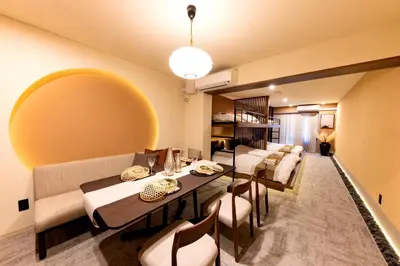 a living room with tables and chairs and a couch at Vistalia in Tokyo