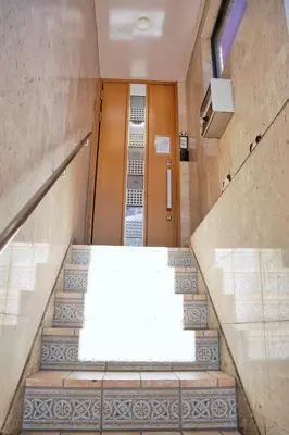 a staircase leading to a door in a building at \u6c11\u5bbf\u521d\u661f in Tokyo