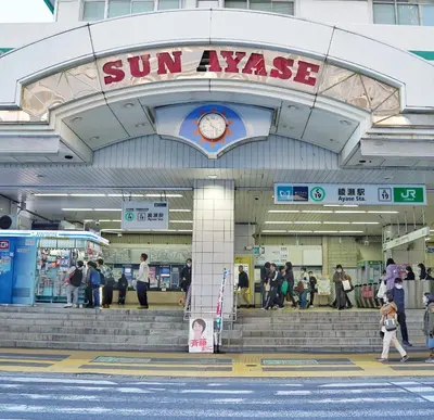 a group of people walking in front of a sun palace building at \u6c11\u5bbf\u521d\u661f in Tokyo