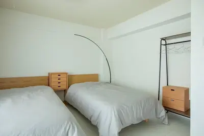 a bedroom with two beds and a mirror at NIYS apartments 55 type in Tokyo