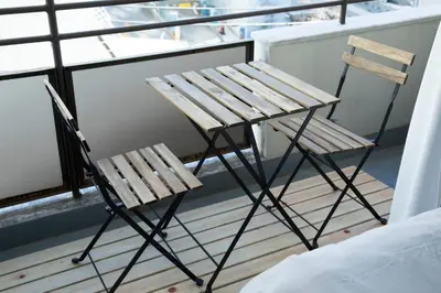 two chairs and a table on a balcony at NIYS apartments 55 type in Tokyo