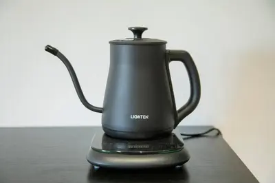 a black electric kettle sitting on a table at NIYS apartments 55 type in Tokyo