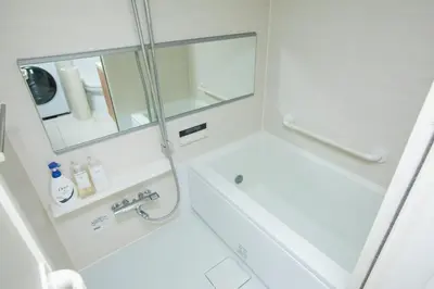 a white bathroom with a shower and a sink at NIYS apartments 55 type in Tokyo