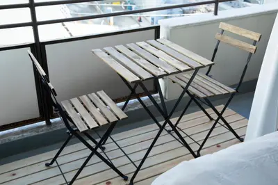 a chair and a table on a balcony at NIYS apartments 55 type in Tokyo