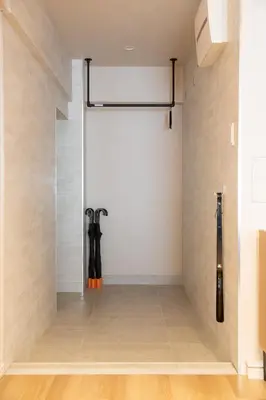 an empty room with a sliding door and baseball bats at NIYS apartments 82type in Tokyo