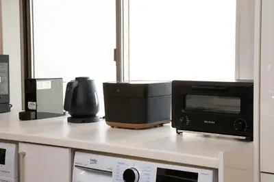 a kitchen counter with a microwave and a toaster oven at NIYS apartments 82type in Tokyo