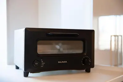 a black toaster oven sitting on top of a counter at NIYS apartments 82type in Tokyo